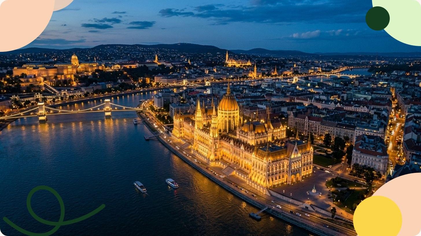 Vista panorámica del Parlamento neogótico de Budapest iluminado al atardecer a orillas del Danubio