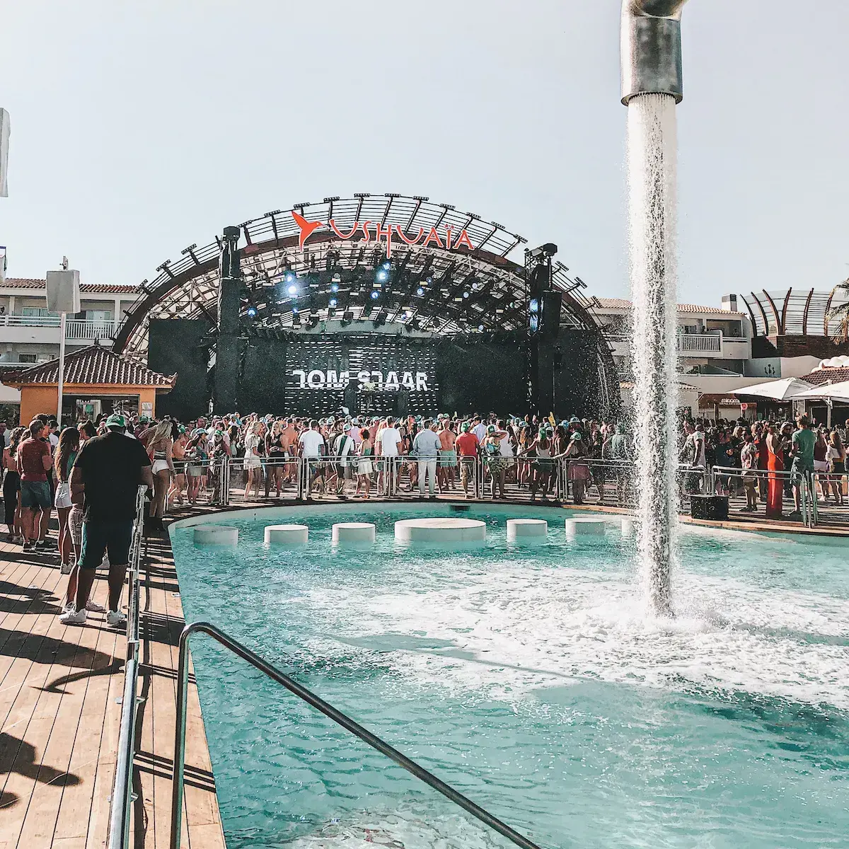 Eine große Konzertbühne an einem türkisfarbenen Pool auf einem Musikfestival am Mittelmeer