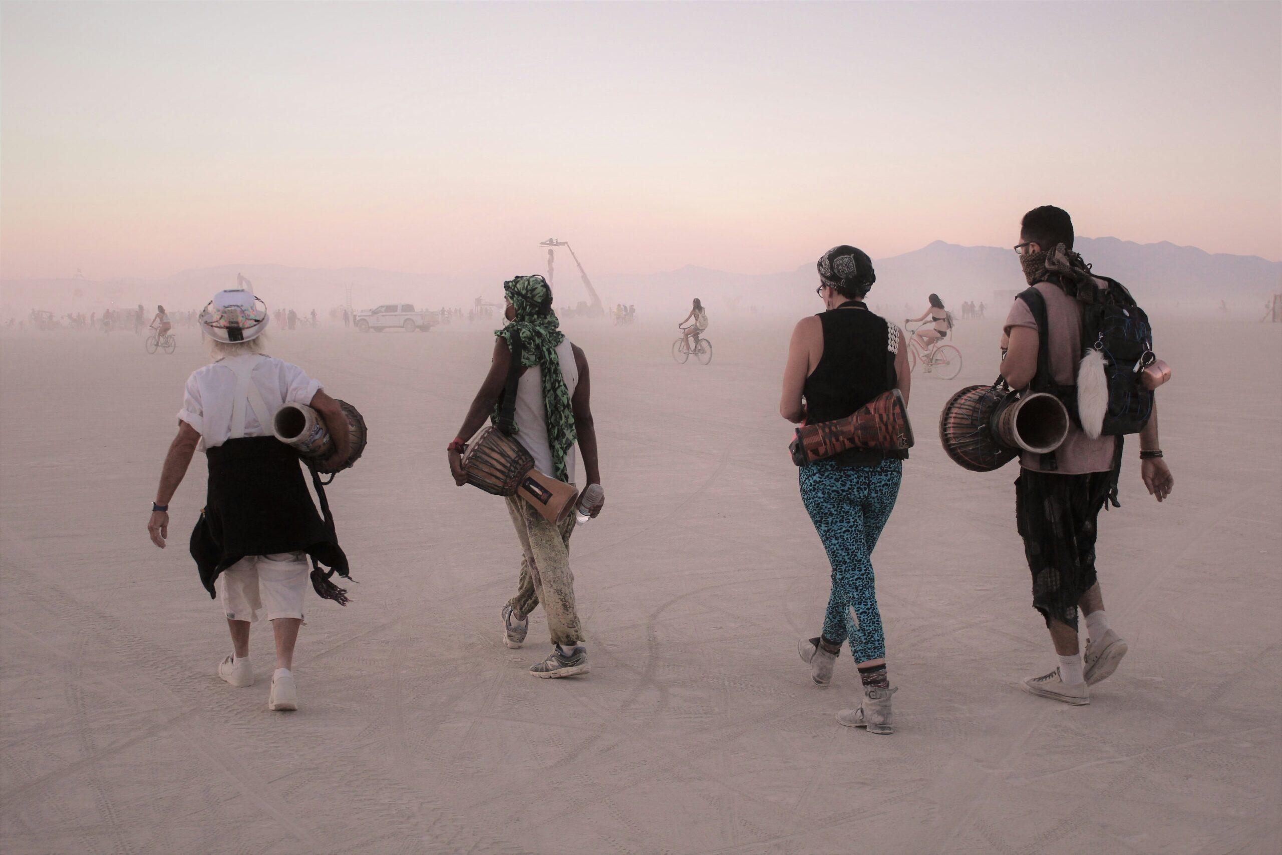 Monumental art installations lit up at sunset during Burning Man in the Nevada desert