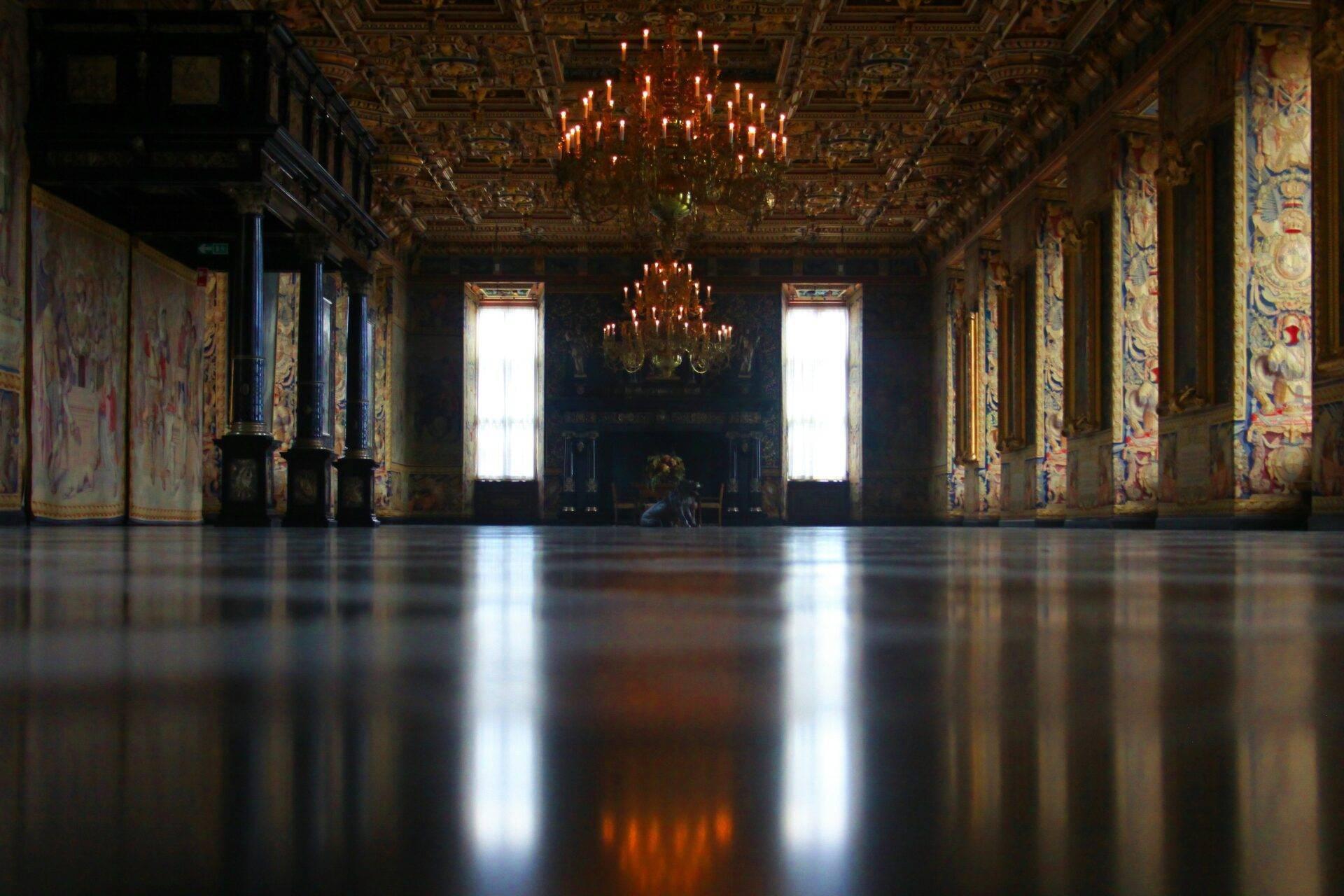 Sala di palazzo ornata d’oro con soffitto riccamente decorato e lampadari, simbolo dell’architettura reale danese