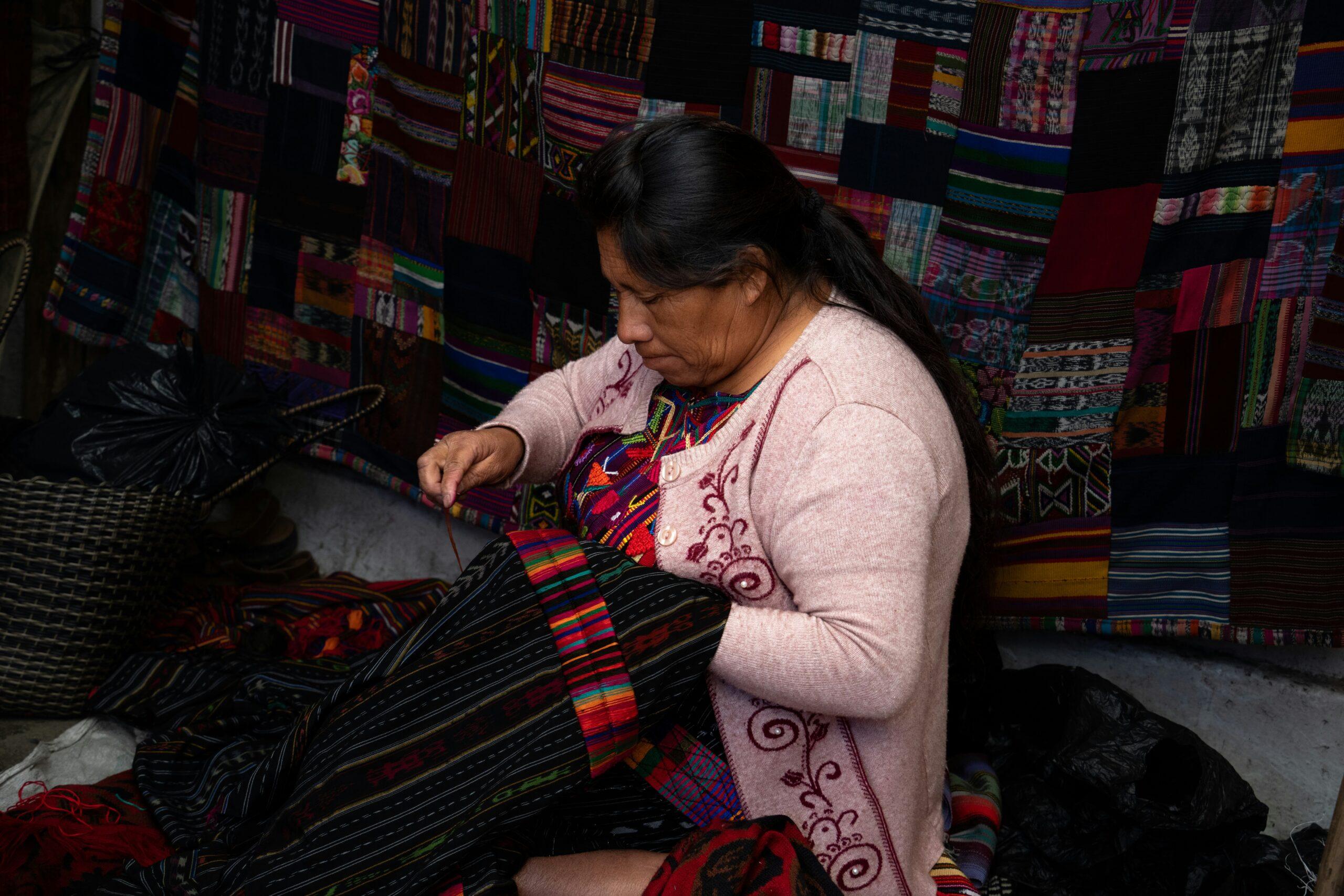Bunte Maya-Textilien und kunsthandwerkliche Masken auf dem traditionellen Markt von Chichicastenango in Guatemala