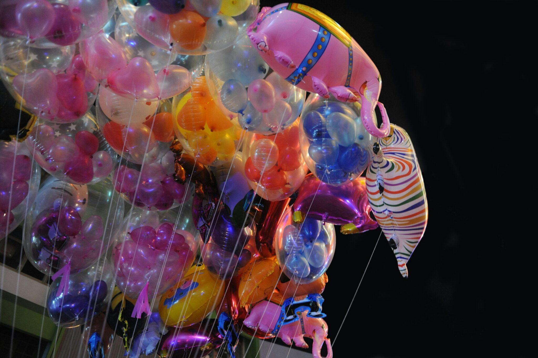 Festive night-time decoration with colourful glowing lanterns suspended in the darkness