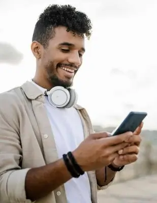happy-man-with-wireless-headphones-using-smart-phone-XLGF02388_1-transformed happy-man-with-wireless-headphones-using-smart-phone-XLGF02388_1-transformed